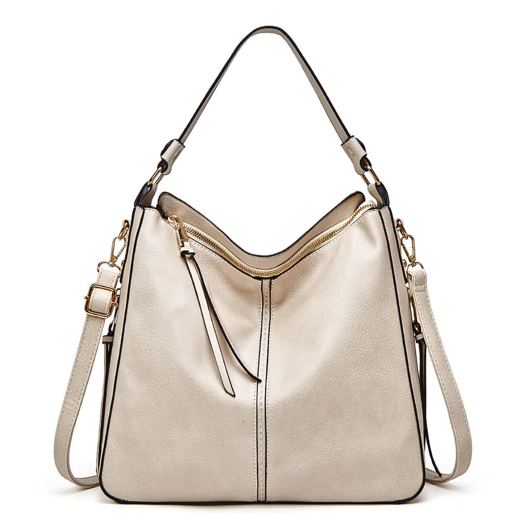Beige leather hobo bag with adjustable shoulder strap and crossbody strap