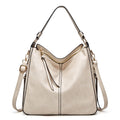 Beige leather hobo bag with adjustable shoulder strap and crossbody strap