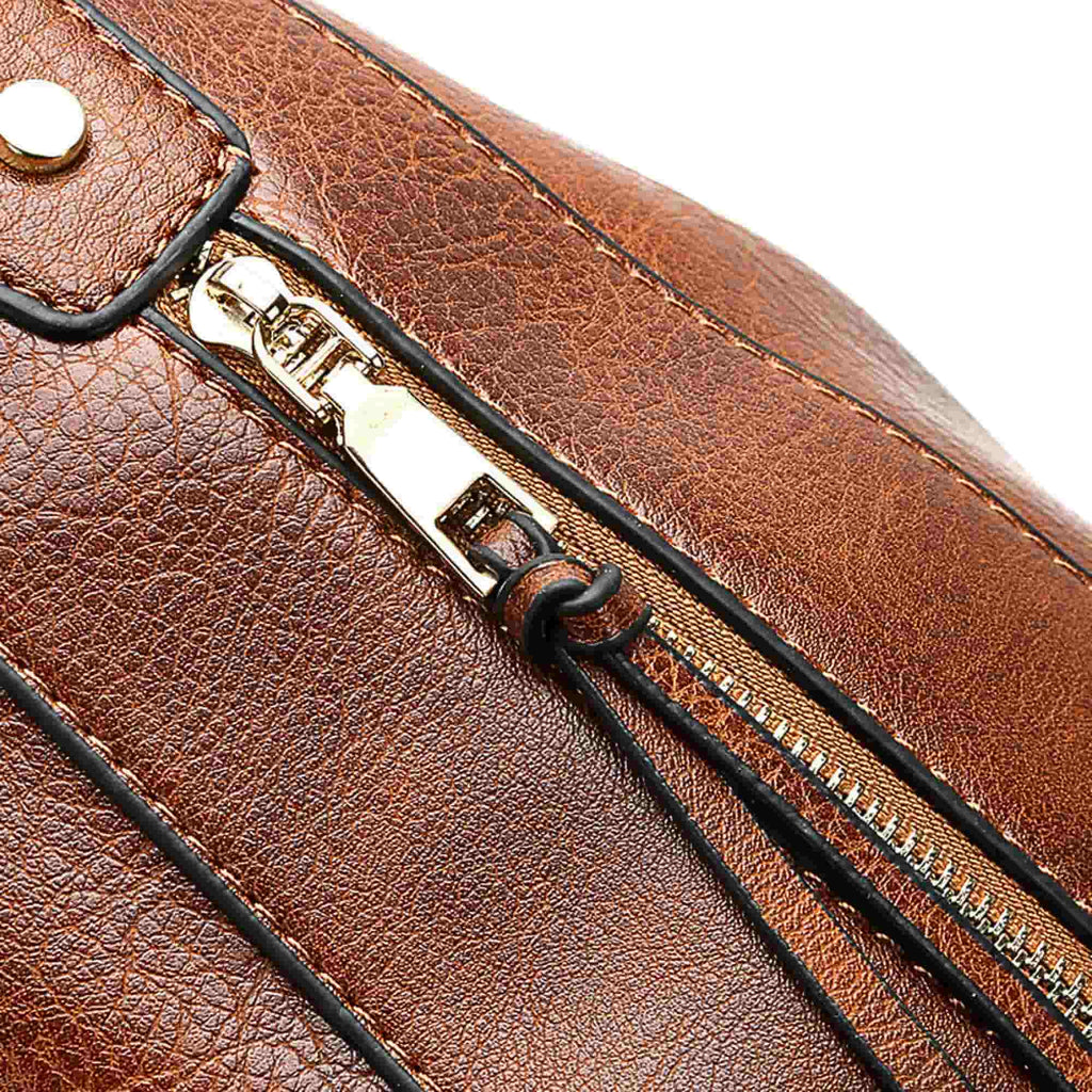 Close-up of gold zipper and stitching detail on brown leather hobo bag